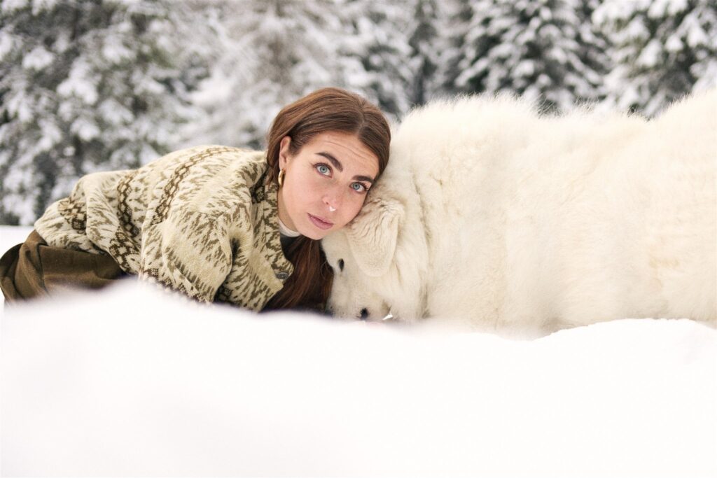 shooting ambientato nel bosco della val di Fassa cane e padrona nella neve - dog photography fotografo professionale di cani Trento